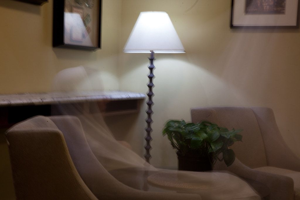 A guest room with a large bed and soft lighting
